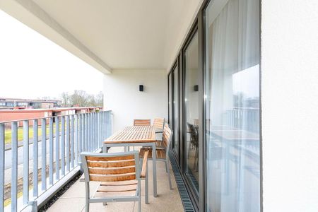 Deichhäuser Anna Küste Deichhäuser Anna Küste 4-23 Bensersiel - Überdachter Balkon mit Sitzgelegenheit in Südwestlicher Lage