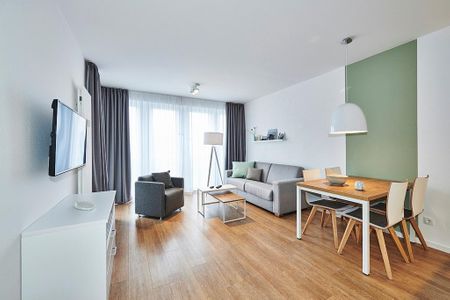 Deichhäuser Anna Küste Deichhäuser Anna Küste 4-24 Bensersiel - Wohn-Essbereich mit Sofa, Esstisch, Sitzgelegenheit und Flatscreen TV