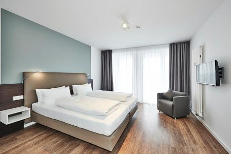 Deichhäuser Anna Küste Deichhäuser Anna Küste 4-31 Bensersiel - Schlafzimmer mit Doppelbett und Zugang zum Balkon