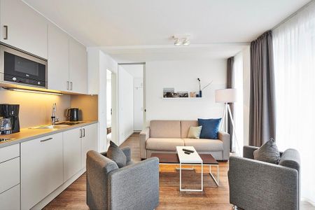 Deichhäuser Anna Küste Deichhäuser Anna Küste 4-33 Bensersiel - Wohnbereich mit Sofa, Sessel und Küchenzeile