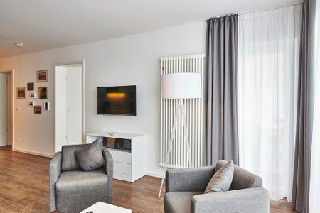 Deichhäuser Anna Küste Deichhäuser Anna Küste 4-34 Bensersiel - Wohnbereich mit Flatscreen-TV und Sitzgelegenheit