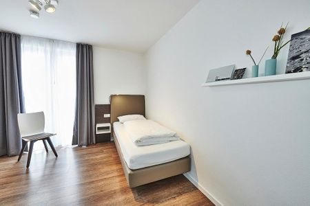 Deichhäuser Anna Küste Deichhäuser Anna Küste 4-34 Bensersiel - Schlafzimmer mit zwei Einzelbetten und Stuhl