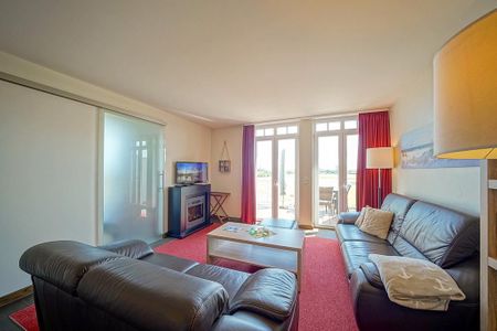 Resort Deichgraf Resort Deichgraf 27-21 Wremen - Wohn-Essbereich mit Couch