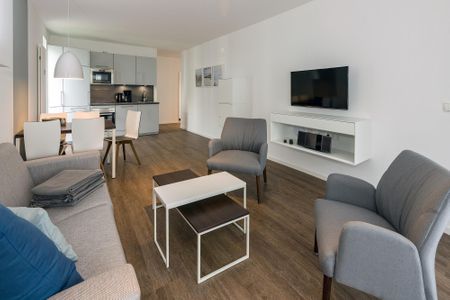 Deichhäuser Anna Küste Deichhäuser Anna Küste 6-20 Bensersiel - Wohn-Essbereich mit Couch und Flatscreen TV