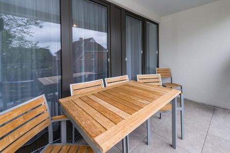 Deichhäuser Anna Küste Deichhäuser Anna Küste 6-20 Bensersiel - Überdachter Balkon mit Sitzgelegenheit
