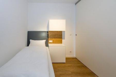 Deichhäuser Anna Küste Deichhäuser Anna Küste 6-21 Bensersiel - Schlafzimmer mit zwei Einzelbetten und Kleiderschrank