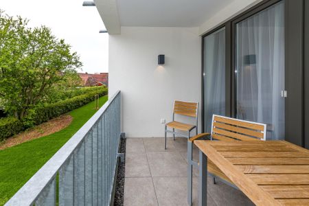Deichhäuser Anna Küste Deichhäuser Anna Küste 6-21 Bensersiel - Überdachter Balkon mit Sitzgelegenheit
