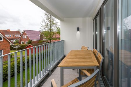 Deichhäuser Anna Küste Deichhäuser Anna Küste 6-23 Bensersiel - Überdachter Balkon mit Sitzgelegenheit