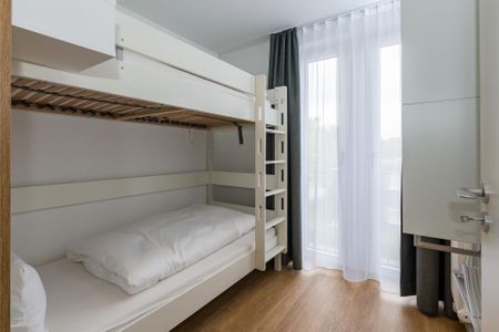 Deichhäuser Anna Küste Deichhäuser Anna Küste 6-30 Bensersiel - Schlafzimmer mit Etagenbett und Kleiderschrank