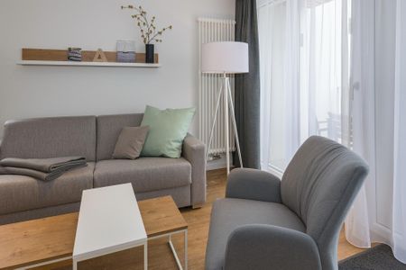 Deichhäuser Anna Küste Deichhäuser Anna Küste 6-31 Bensersiel - Wohn-Essbereich mit Couch