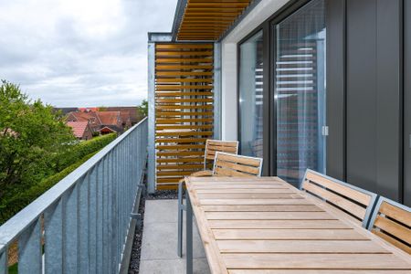 Deichhäuser Anna Küste Deichhäuser Anna Küste 6-31 Bensersiel - Überdachter Balkon mit Sitzgelegenheit