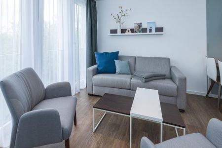 Deichhäuser Anna Küste Deichhäuser Anna Küste 6-34 Bensersiel - Wohn-Essbereich mit Couch