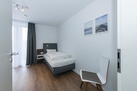 Deichhäuser Anna Küste Deichhäuser Anna Küste 6-34 Bensersiel - Schlafzimmer mit zwei Einzelbetten und Stuhl