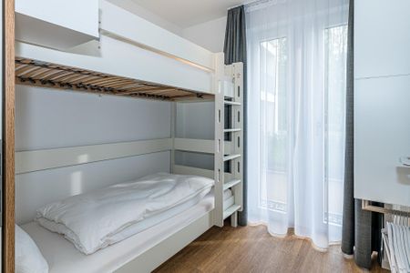 Deichhäuser Anna Küste Deichhäuser Anna Küste 7-10 Bensersiel - Schlafzimmer mit Etagenbett und Kleiderschrank