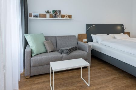 Deichhäuser Anna Küste Deichhäuser Anna Küste 7-22 Bensersiel - Wohn-Ess-Schlafbereich mit Sofa und Doppelbett