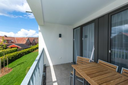 Deichhäuser Anna Küste Deichhäuser Anna Küste 7-23 Bensersiel - Überdachter Balkon mit Sitzgelegenheit