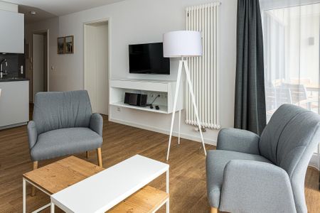 Deichhäuser Anna Küste Deichhäuser Anna Küste 7-34 Bensersiel - Wohn-Essbereich mit Couch