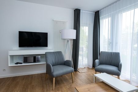 Deichhäuser Anna Küste Deichhäuser Anna Küste 8-14 Bensersiel - Wohn-Essbereich mit Couch