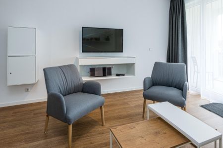 Deichhäuser Anna Küste Deichhäuser Anna Küste 8-20 Bensersiel - Wohn-Essbereich mit Couch