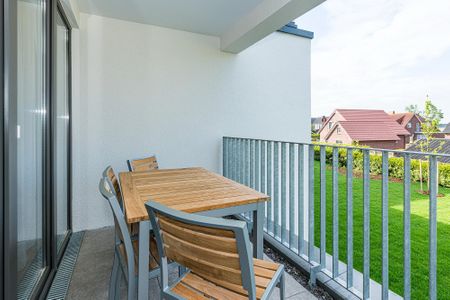 Deichhäuser Anna Küste Deichhäuser Anna Küste 8-21 Bensersiel - Überdachter Balkon mit Sitzgelegenheit