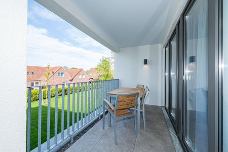 Deichhäuser Anna Küste Deichhäuser Anna Küste 8-23 Bensersiel - Überdachter Balkon mit Sitzgelegenheit