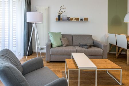 Deichhäuser Anna Küste Deichhäuser Anna Küste 8-30 Bensersiel - Wohn-Essbereich mit Couch