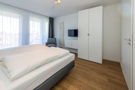 Deichhäuser Anna Küste Deichhäuser Anna Küste 8-31 Bensersiel - Schlafzimmer mit Doppelbett und Flatscreen TV