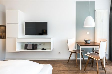 Deichhäuser Anna Küste Deichhäuser Anna Küste 8-32 Bensersiel - Wohn-Ess-Schlafbereich mit Couch und Flatscreen-TV