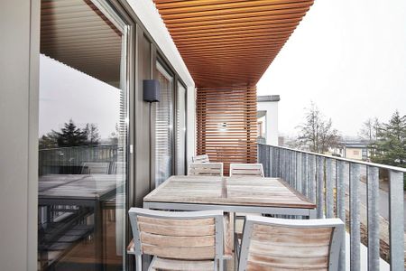 Deichhäuser Anna Küste Deichhäuser Anna Küste 4-30 Bensersiel - Überdachter Balkon mit Sitzgelegenheit
