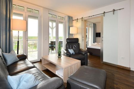 Resort Deichgraf Resort Deichgraf 31-11 Wremen - Wohn-Essbereich mit Couch