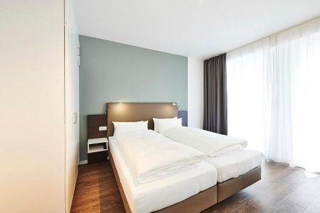 Deichhäuser Anna Küste Deichhäuser Anna Küste 2-11 Bensersiel - Schlafzimmer mit Doppelbett und Kleiderschrank