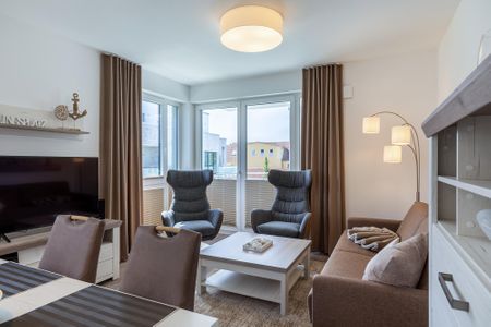 Aparthotel Ostseeallee Aparthotel Ostseeallee 2-12 Boltenhagen - Wohn-/Essbereich mit Doppelschlafcouch, Couchtisch, Sessel, TV, Esstisch,