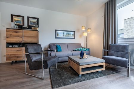Aparthotel Ostseeallee Aparthotel Ostseeallee 2-13 Boltenhagen - Wohnbereich mit Doppelschlafcouch und Couchtisch