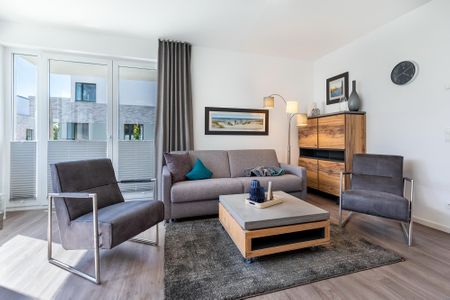 Aparthotel Ostseeallee Aparthotel Ostseeallee 5-44 Boltenhagen - Wohn-/Essbereich mit Doppelschlafcouch, Couchtisch und Sessel