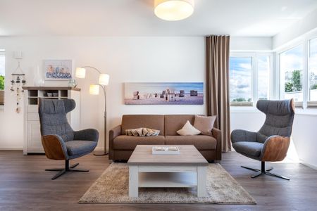 Aparthotel Ostseeallee Aparthotel Ostseeallee 5-46 Boltenhagen - Wohn-/Essbereich mit Doppelschlafcouch, Couchtisch und Sessel