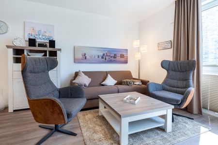 Aparthotel Ostseeallee Aparthotel Ostseeallee 2-09 Boltenhagen - Wohn-/Essbereich mit Doppelschlafcouch und Sessel