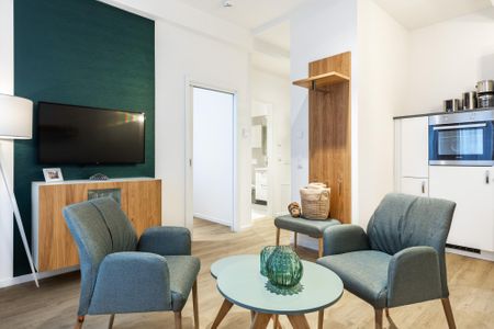 Ferienapartments am Krusespeicher Ferienapartments am Krusespeicher 2-18 Wismar - Wohn-/Essbereich mit Flatscreen-TV