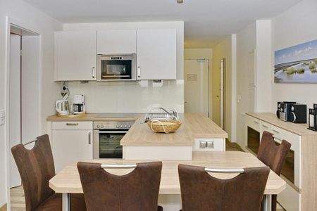 Resort Deichgraf Resort Deichgraf 27-14 Wremen - Küchenzeile mit Esstisch und Sitzgelegenheit