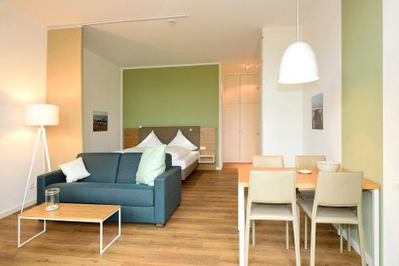 Aparthotel Anna Düne Aparthotel Anna Düne 0-02 Wangerooge - Wohn/ Essbereich mit Couch und Esstisch