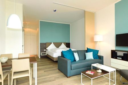 Aparthotel Anna Düne Aparthotel Anna Düne 0-05 Wangerooge - Wohn/ Essbereich mit Couch und Fernseher