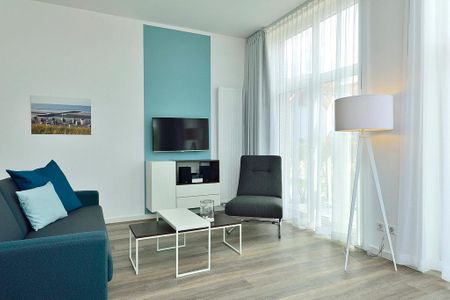 Aparthotel Anna Düne Aparthotel Anna Düne 0-06 Wangerooge - Wohn/ Essbereich mit Couch, Sessel und Fernseher