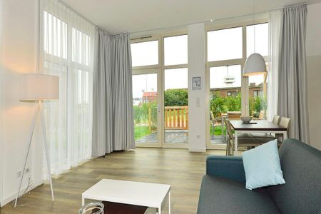 Aparthotel Anna Düne Aparthotel Anna Düne 0-06 Wangerooge - Wohn/ Essbereich mit Couch und Tisch