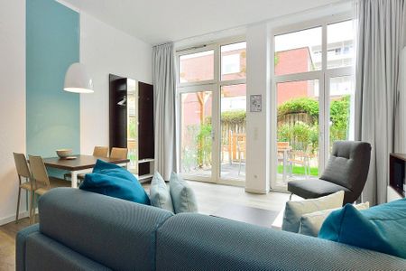 Aparthotel Anna Düne Aparthotel Anna Düne 0-09 Wangerooge - Wohn/ Essbereich mit Couch, Sessel und Esstisch