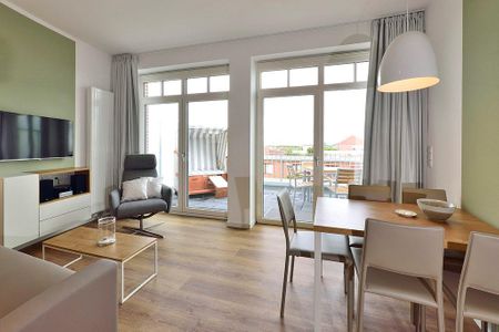 Aparthotel Anna Düne Aparthotel Anna Düne 1-15 Wangerooge - Wohn/ Essbereich mit Couch, Fernseher und Esstisch