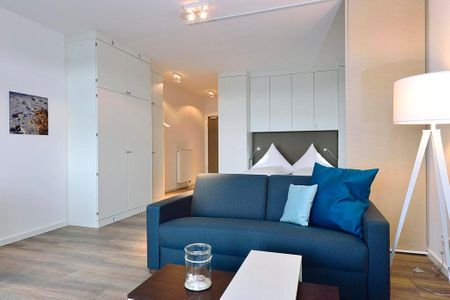 Aparthotel Anna Düne Aparthotel Anna Düne 1-17 Wangerooge - Wohn/ Essbereich mit Couch
