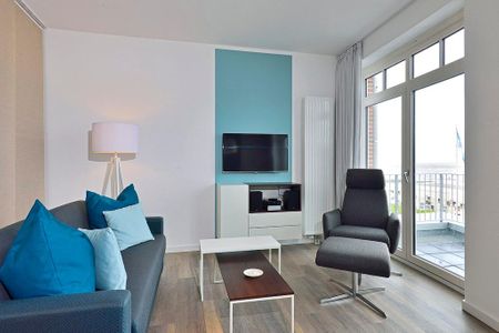 Aparthotel Anna Düne Aparthotel Anna Düne 1-22 Wangerooge - Wohn/ Essbereich mit Couch, Sessel und Fernseher