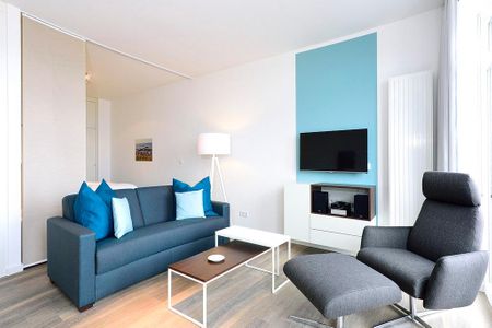 Aparthotel Anna Düne Aparthotel Anna Düne 1-22 Wangerooge - Wohn/ Essbereich mit Fernseher