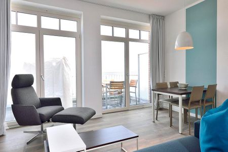 Aparthotel Anna Düne Aparthotel Anna Düne 1-22 Wangerooge - Wohn/ Essbereich mit Sessel