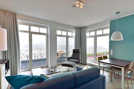Aparthotel Anna Düne Aparthotel Anna Düne 1-24 Wangerooge - Wohn/ Essbereich mit Couch und Esstisch