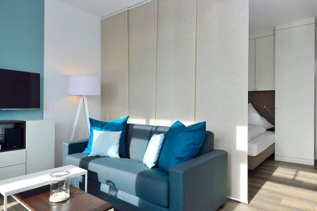 Aparthotel Anna Düne Aparthotel Anna Düne 2-29 Wangerooge - Wohn/ Essbereich mit Couch